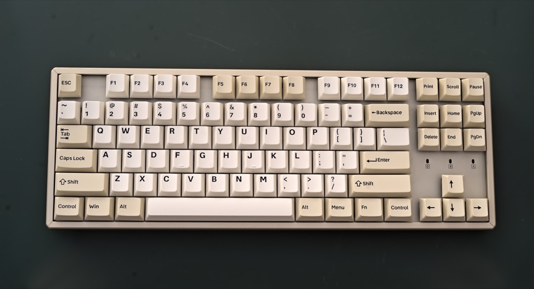A tenkeyless mechanical keyboard with PBT keycaps on a developer's desk, reviewed as one of the best mechanical keyboards for programmers