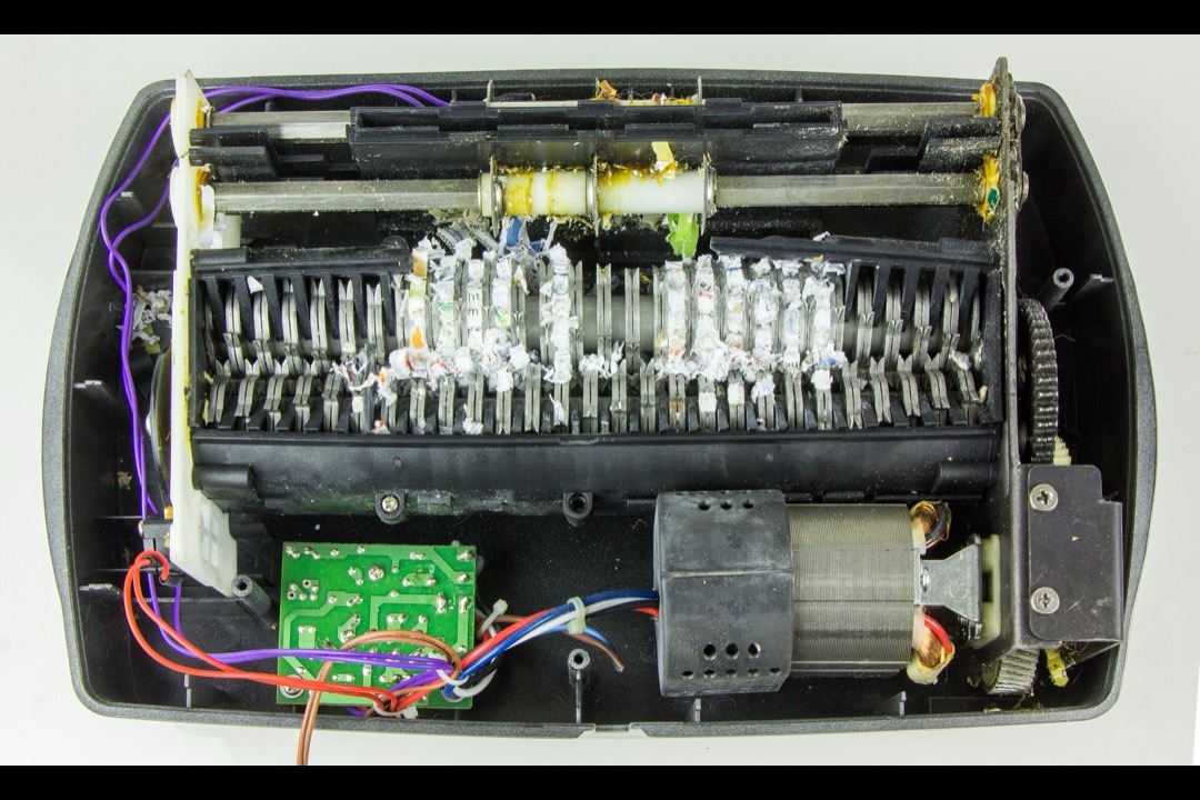 A paper shredder on a desk in a modern office environment