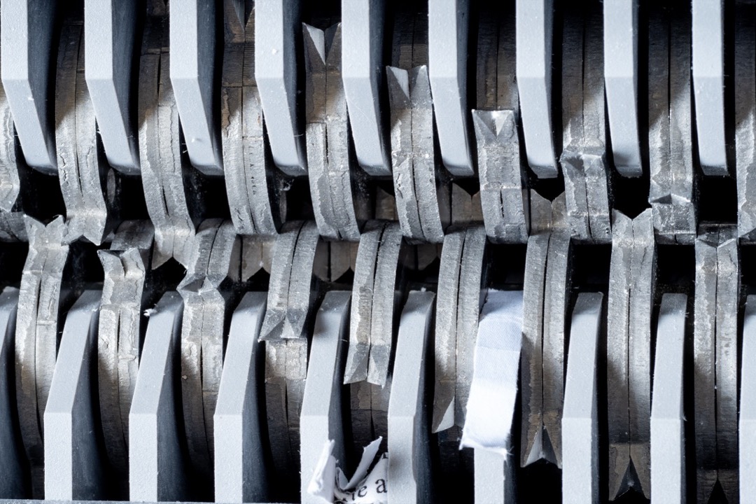 Close-up of the cutting blades inside a paper shredder
