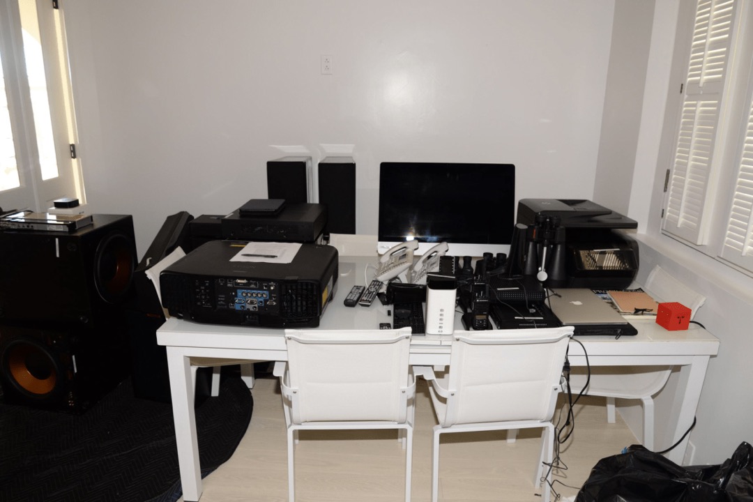 A clean modern home office desk setup with monitors, keyboard, and office supplies