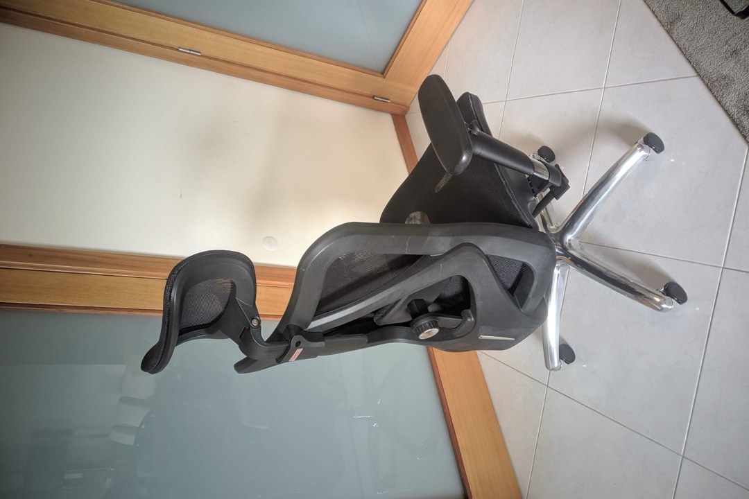 A modern mesh back office chair against a clean office background