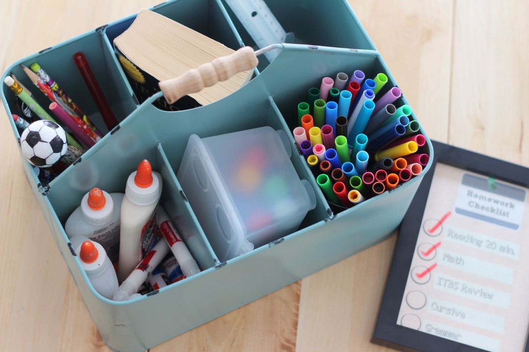Office desk with a calculator, spreadsheet, pens, and stacked supplies representing an office supply budget